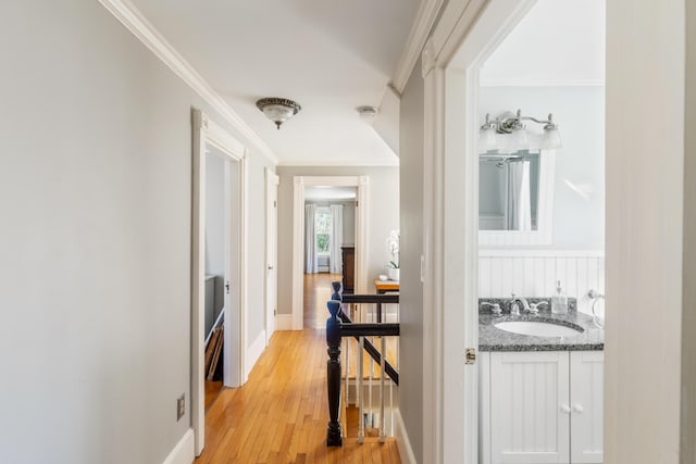 11 Summer St, Kennebunk, ME 04043 - corridor with a sink, ornamental molding, an upstairs landing, light wood-type flooring, and baseboards