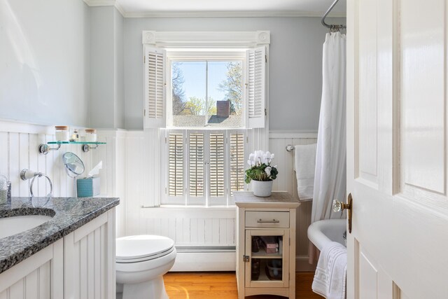 11 Summer St, Kennebunk, ME 04043 - full bathroom with a wainscoted wall, baseboard heating, a decorative wall, vanity, and ornamental molding