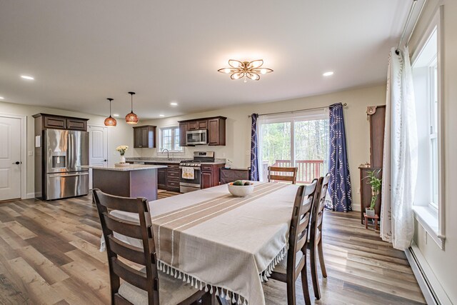 14 Bluebird Trl Unit 67, Falmouth, ME 04105 - dining area with a baseboard heating unit, wood finished floors, recessed lighting, and baseboards