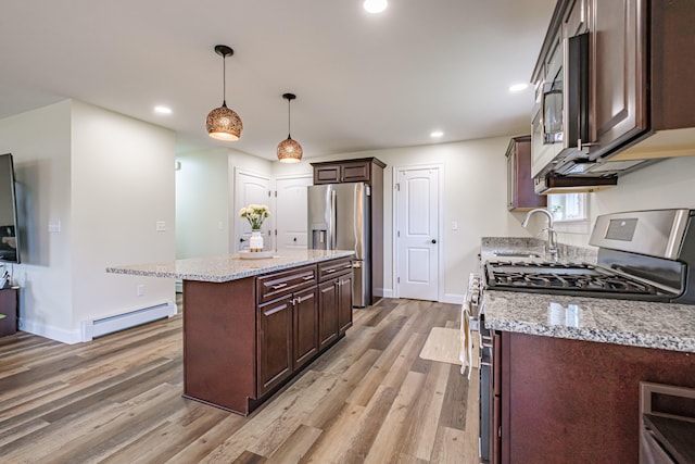 14 Bluebird Trl Unit 67, Falmouth, ME 04105 - kitchen with stainless steel appliances, a baseboard heating unit, a sink, light wood finished floors, and dark brown cabinetry