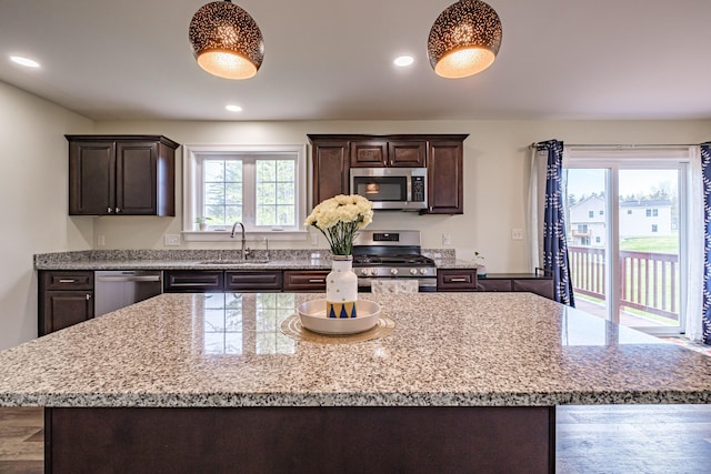 14 Bluebird Trl Unit 67, Falmouth, ME 04105 - kitchen with appliances with stainless steel finishes, a sink, dark brown cabinetry, a center island, and recessed lighting