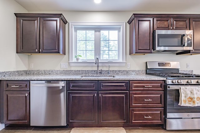 14 Bluebird Trl Unit 67, Falmouth, ME 04105 - kitchen featuring appliances with stainless steel finishes, a sink, dark brown cabinetry, recessed lighting, and wood finished floors