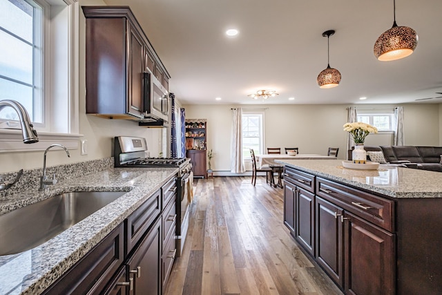 14 Bluebird Trl Unit 67, Falmouth, ME 04105 - kitchen with stainless steel appliances, a sink, hardwood / wood-style flooring, recessed lighting, and hanging light fixtures