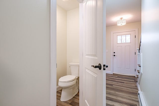 14 Bluebird Trl Unit 67, Falmouth, ME 04105 - bathroom featuring wood finished floors, baseboard heating, toilet, and baseboards