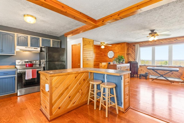 414 Oak Hill Rd, Litchfield, ME 04350 - kitchen with electric range, under cabinet range hood, a textured ceiling, a ceiling fan, and freestanding refrigerator