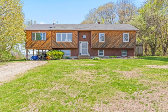 414 Oak Hill Rd, Litchfield, ME 04350 - bi-level home with a front yard and dirt driveway