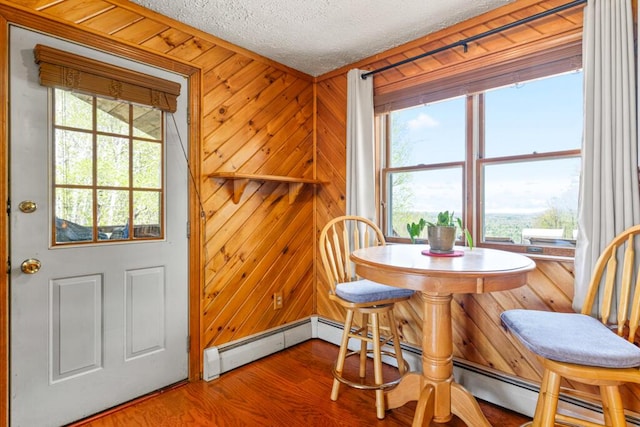 414 Oak Hill Rd, Litchfield, ME 04350 - dining space featuring a textured ceiling, wood finished floors, and wooden walls