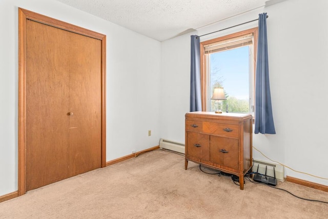 414 Oak Hill Rd, Litchfield, ME 04350 - bedroom featuring light carpet, a baseboard heating unit, baseboards, and a textured ceiling