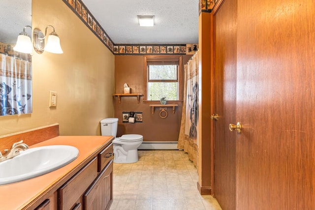 414 Oak Hill Rd, Litchfield, ME 04350 - bathroom featuring baseboard heating, toilet, a textured ceiling, vanity, and curtained shower