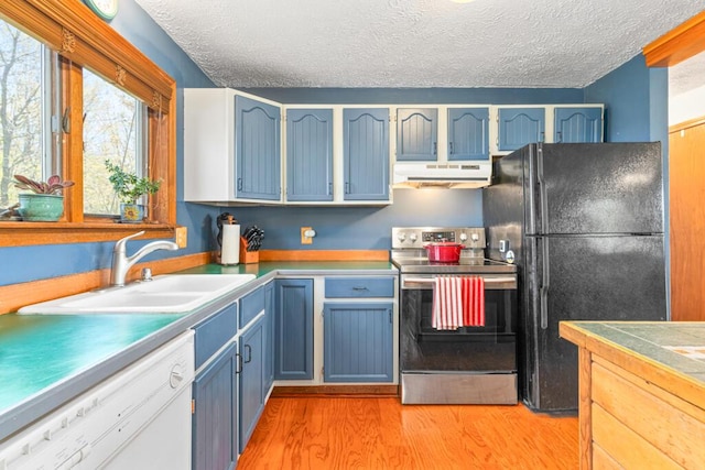 414 Oak Hill Rd, Litchfield, ME 04350 - kitchen with stainless steel electric range oven, freestanding refrigerator, under cabinet range hood, white dishwasher, and a sink
