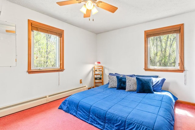 414 Oak Hill Rd, Litchfield, ME 04350 - bedroom with a baseboard heating unit, carpet floors, a textured ceiling, and ceiling fan