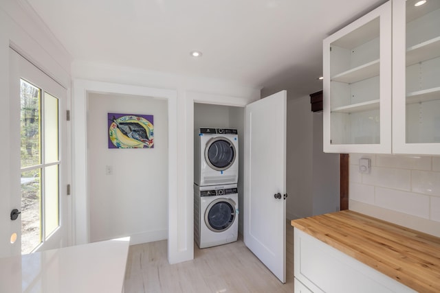 360 Vinal St, Rockport, ME 04856 - clothes washing area featuring stacked washer and clothes dryer, light wood-style floors, recessed lighting, and baseboards