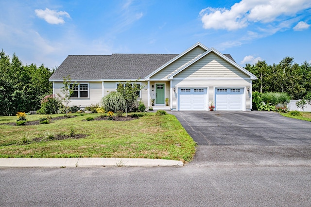 48 Sancho Dr, Saco, ME 04072 - view of front of house featuring a garage, asphalt driveway, a front lawn, and roof with shingles