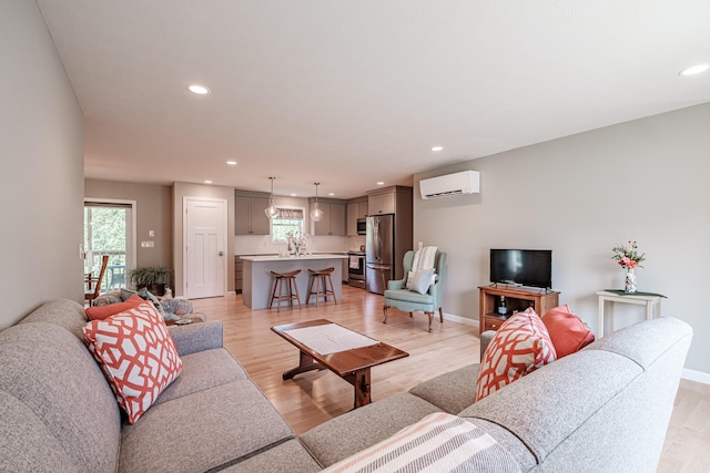 48 Sancho Dr, Saco, ME 04072 - living area featuring a wall unit AC, recessed lighting, light wood-type flooring, and baseboards