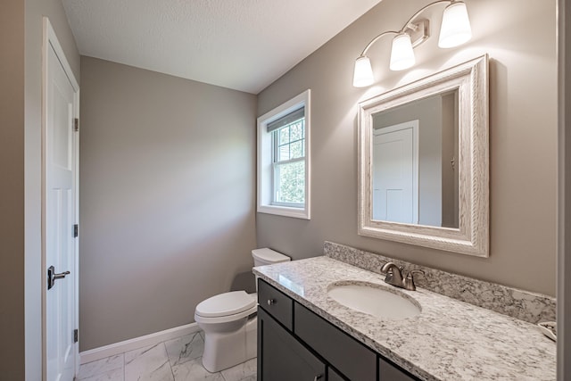 48 Sancho Dr, Saco, ME 04072 - bathroom with marble finish flooring, toilet, vanity, baseboards, and a textured ceiling