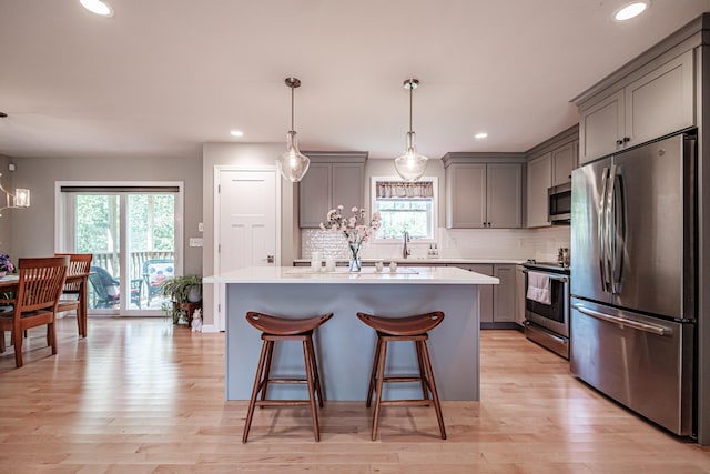 48 Sancho Dr, Saco, ME 04072 - kitchen with stainless steel appliances, gray cabinetry, backsplash, a kitchen island, and recessed lighting