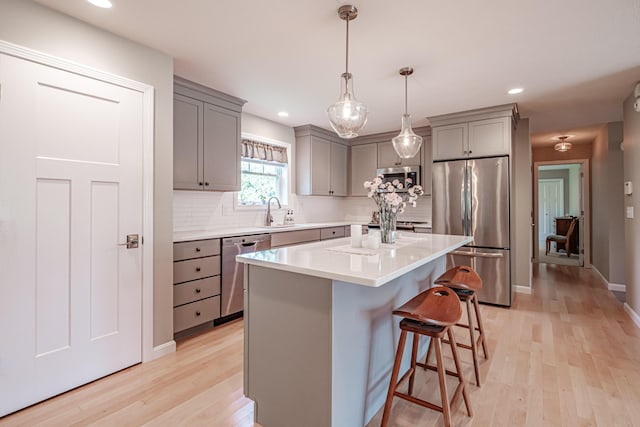 48 Sancho Dr, Saco, ME 04072 - kitchen with gray cabinetry, stainless steel appliances, a sink, light wood-style flooring, and recessed lighting