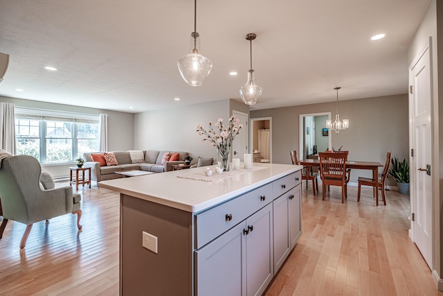 48 Sancho Dr, Saco, ME 04072 - kitchen featuring gray cabinets, a center island, light wood-style floors, recessed lighting, and light countertops