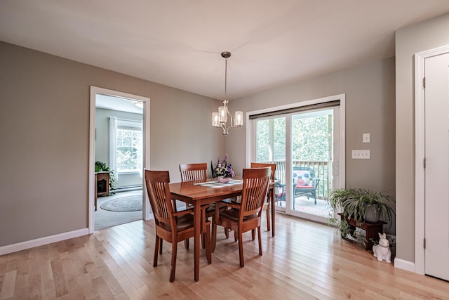 48 Sancho Dr, Saco, ME 04072 - dining space featuring a chandelier, light wood-style floors, baseboards, and a baseboard heating unit