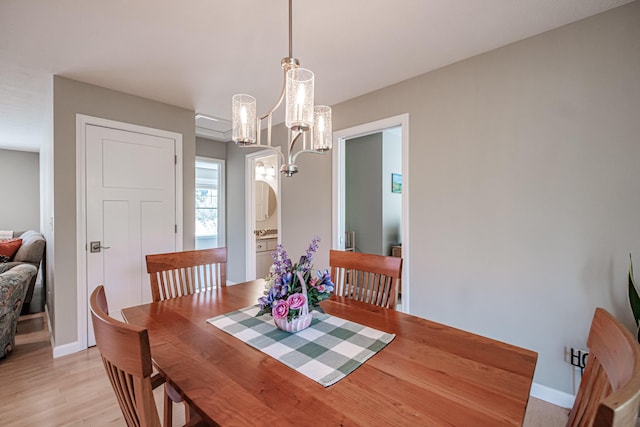 48 Sancho Dr, Saco, ME 04072 - dining room featuring a chandelier, light wood finished floors, and baseboards