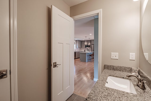 48 Sancho Dr, Saco, ME 04072 - bathroom featuring wood finished floors, vanity, and recessed lighting