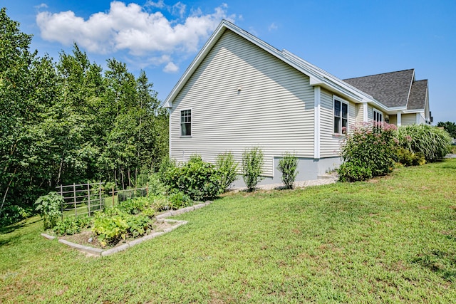 48 Sancho Dr, Saco, ME 04072 - view of side of property featuring a yard, a garden, and a shingled roof