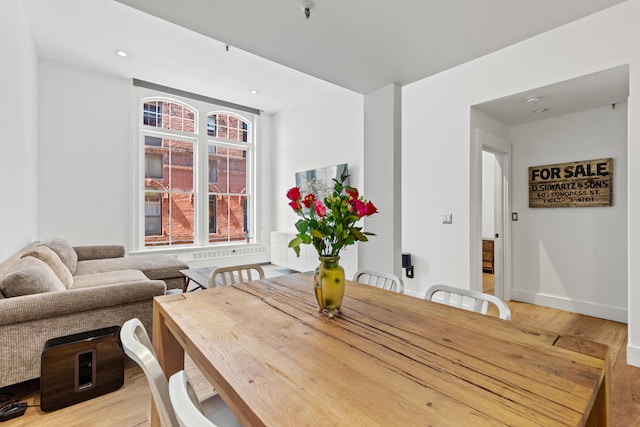 dining room featuring light wood finished floors, baseboards, and recessed lighting