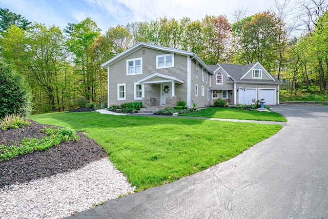 71 Brook Rd, Falmouth, ME 04105 - view of front of property with an attached garage, asphalt driveway, and a front lawn