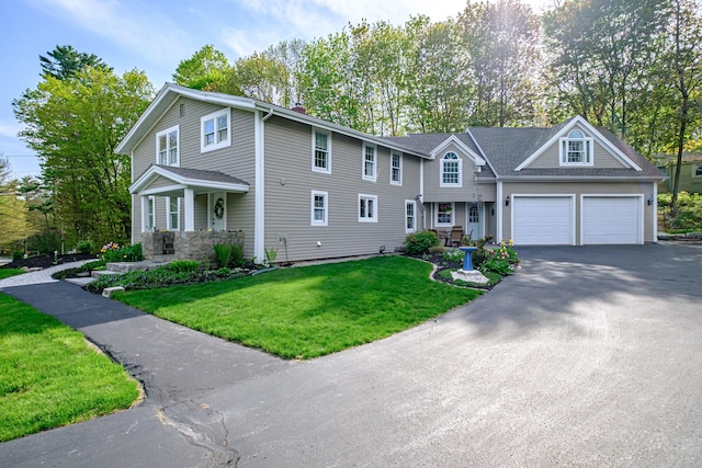 71 Brook Rd, Falmouth, ME 04105 - view of front of house with driveway, an attached garage, a front lawn, and a chimney