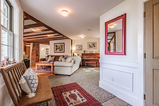 71 Brook Rd, Falmouth, ME 04105 - tiled living area with plenty of natural light and beam ceiling