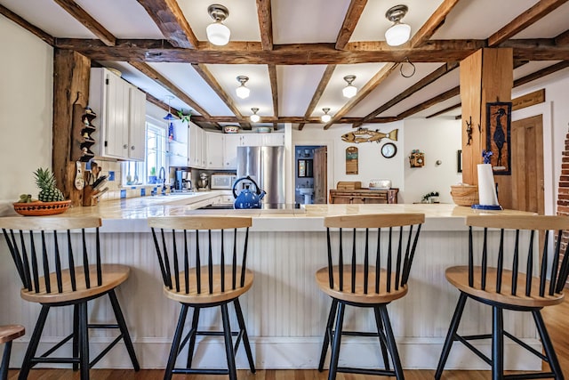 71 Brook Rd, Falmouth, ME 04105 - kitchen featuring freestanding refrigerator, a peninsula, white cabinetry, tile counters, and coffered ceiling