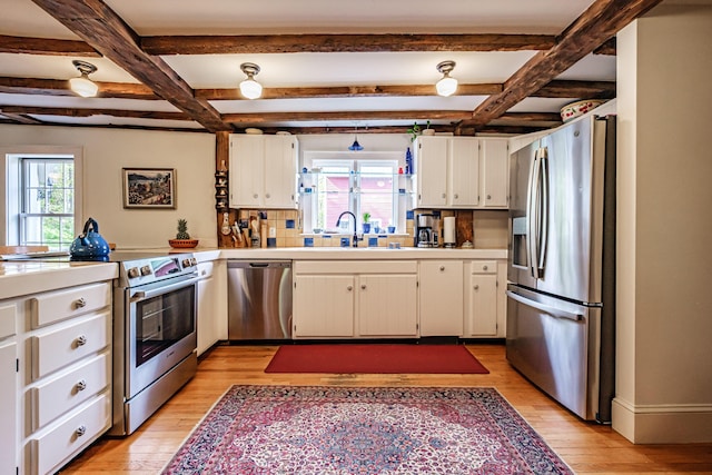 71 Brook Rd, Falmouth, ME 04105 - kitchen featuring stainless steel appliances, a sink, light wood finished floors, light countertops, and white cabinets