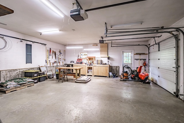71 Brook Rd, Falmouth, ME 04105 - garage with a garage door opener and a workshop area