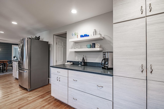 28 Stone Dr, Cape Elizabeth, ME 04107 - kitchen with freestanding refrigerator, dark countertops, light wood-style flooring, recessed lighting, and modern cabinets
