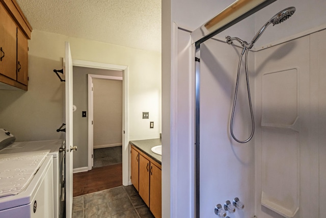 55 Reservoir Rd, Paris, ME 04281 - bathroom featuring a shower, washing machine and clothes dryer, vanity, and a textured ceiling