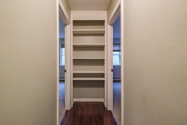 55 Reservoir Rd, Paris, ME 04281 - hallway featuring dark wood finished floors, a textured ceiling, baseboard heating, and baseboards