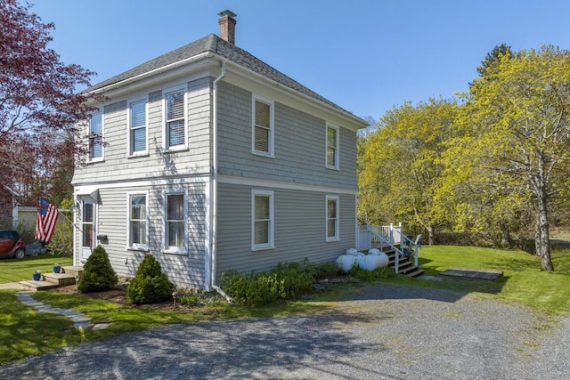14 Williams St, Boothbay Harbor, ME 04538 - view of property exterior featuring a chimney, a yard, and roof with shingles