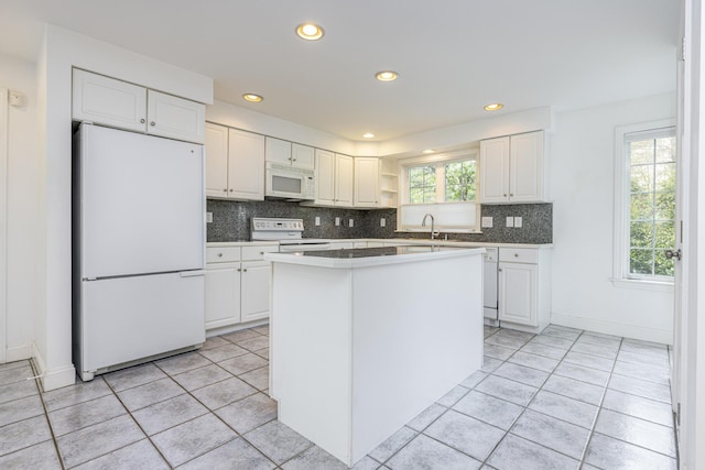 5 Honeysuckle Ln, Scarborough, ME 04074 - kitchen featuring white appliances, white cabinetry, light tile patterned floors, tasteful backsplash, and open shelves