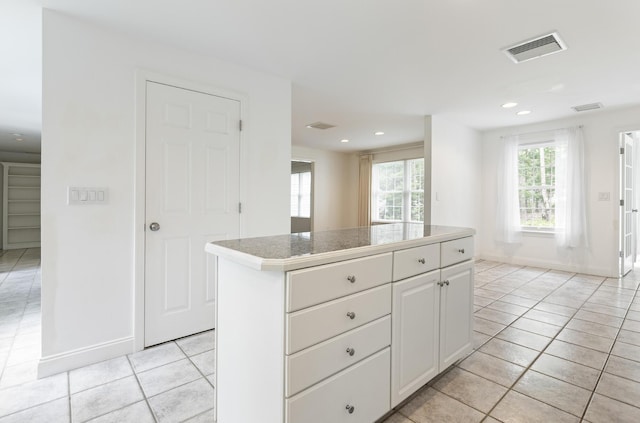 5 Honeysuckle Ln, Scarborough, ME 04074 - kitchen with recessed lighting, light tile patterned floors, baseboards, a center island, and white cabinetry