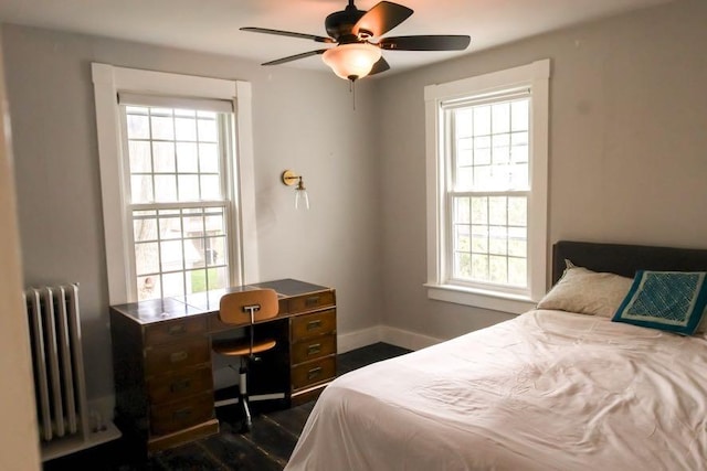56 Savage St, Bangor, ME 04401 - bedroom with radiator, baseboards, dark wood-type flooring, a desk, and ceiling fan
