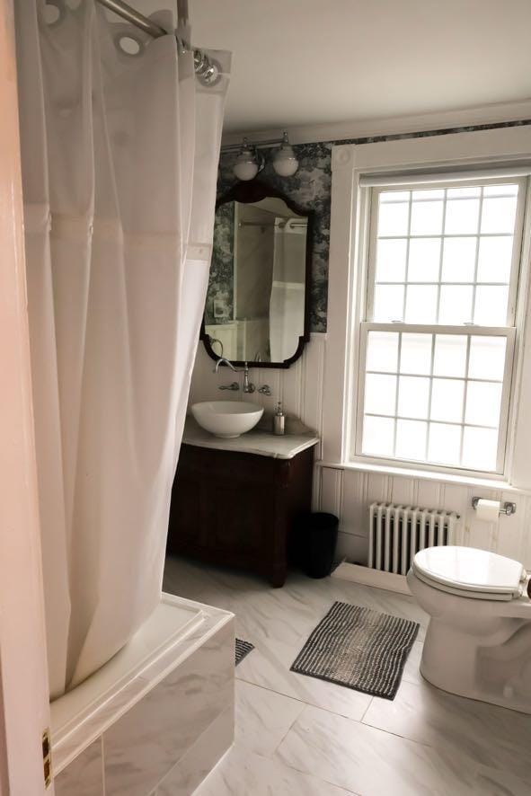 56 Savage St, Bangor, ME 04401 - full bathroom featuring radiator, a shower with curtain, toilet, vanity, and marble finish floors