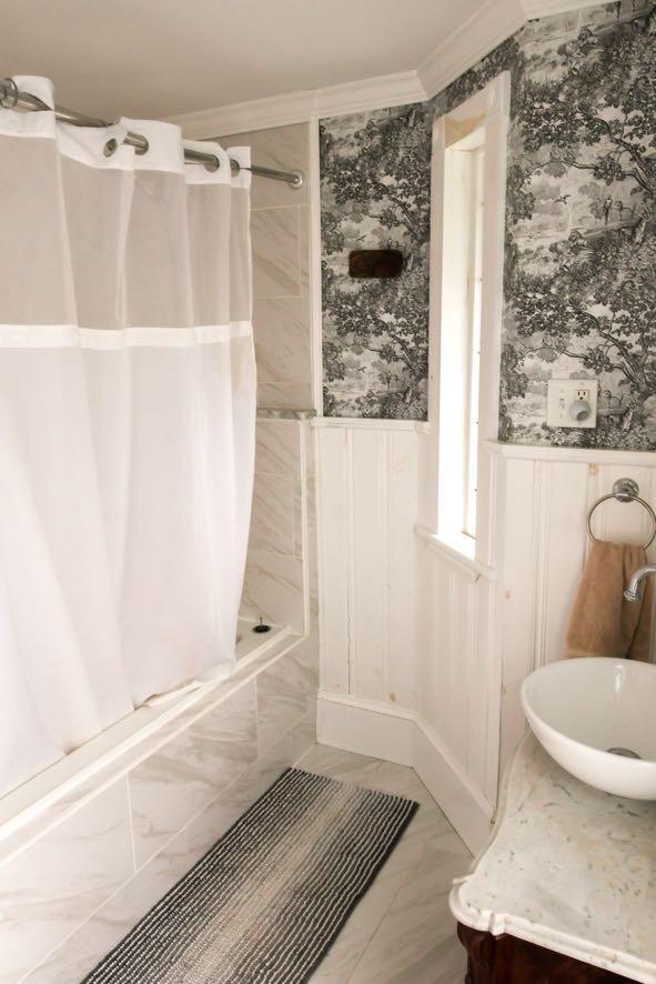 56 Savage St, Bangor, ME 04401 - bathroom with crown molding, wainscoting, tiled shower / bath, marble look tiles, and vanity