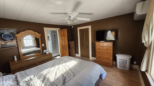 295 Grove St, Bangor, ME 04401 - bedroom with a wall mounted air conditioner, wood finished floors, ceiling fan, and baseboards