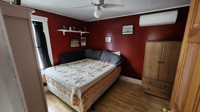 295 Grove St, Bangor, ME 04401 - bedroom featuring a wall mounted air conditioner, wood finished floors, ornamental molding, baseboards, and a ceiling fan