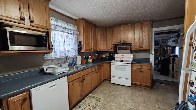 295 Grove St, Bangor, ME 04401 - kitchen with white appliances, brown cabinetry, and dark countertops