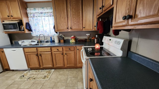 295 Grove St, Bangor, ME 04401 - kitchen with white appliances, brown cabinets, a sink, and dark countertops
