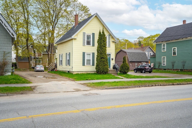 192 Wilson St, Brewer, ME 04412 - traditional home featuring a chimney and asphalt driveway