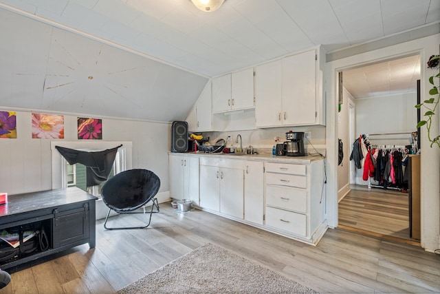 192 Wilson St, Brewer, ME 04412 - kitchen featuring white cabinetry, light wood-type flooring, light countertops, a sink, and lofted ceiling