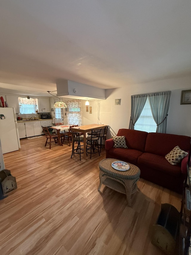 26-28 Acorn Rd, Naples, ME 04055 - living area with plenty of natural light and light wood-style flooring