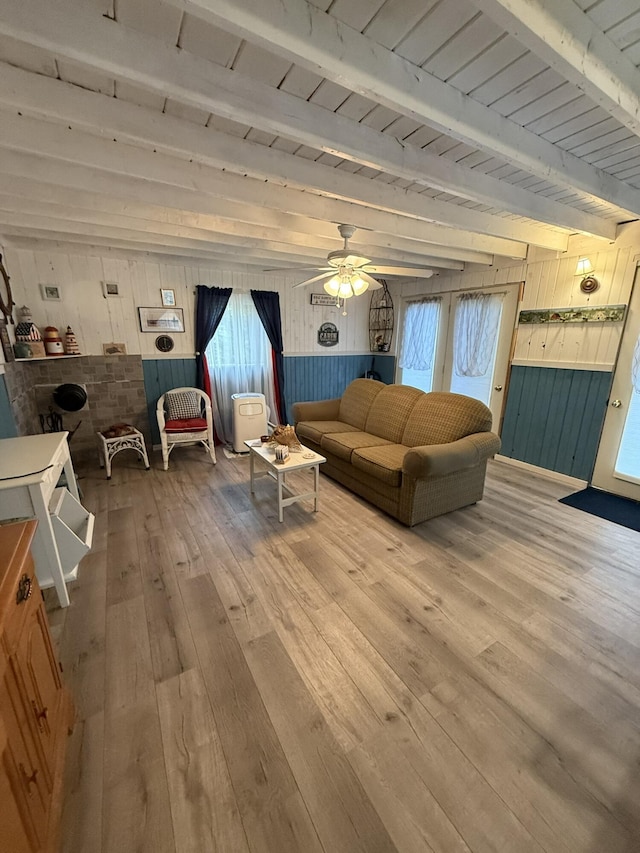 26-28 Acorn Rd, Naples, ME 04055 - living room featuring wooden walls, hardwood / wood-style floors, wooden ceiling with exposed beams, and a ceiling fan